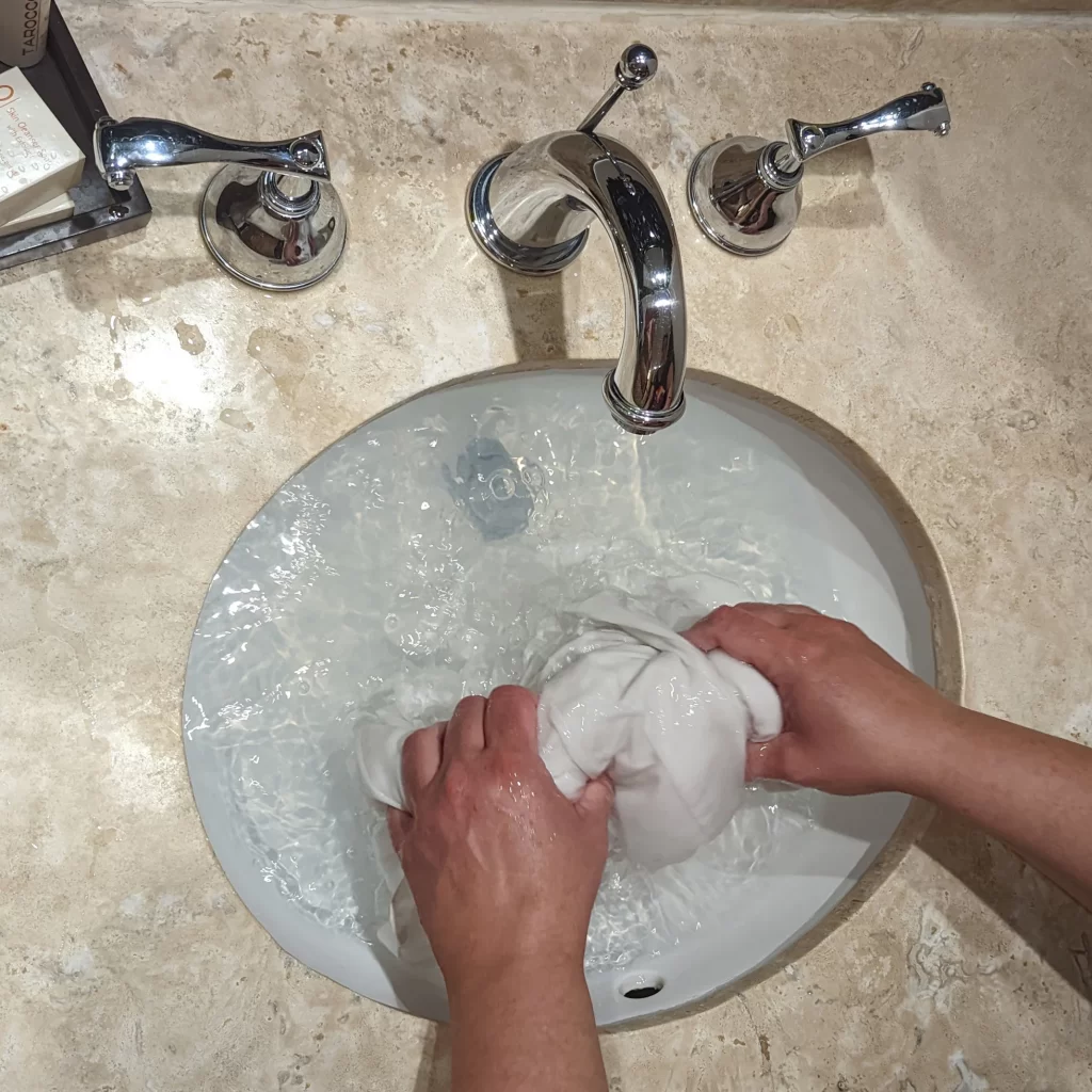 Washing clothes in a sink.