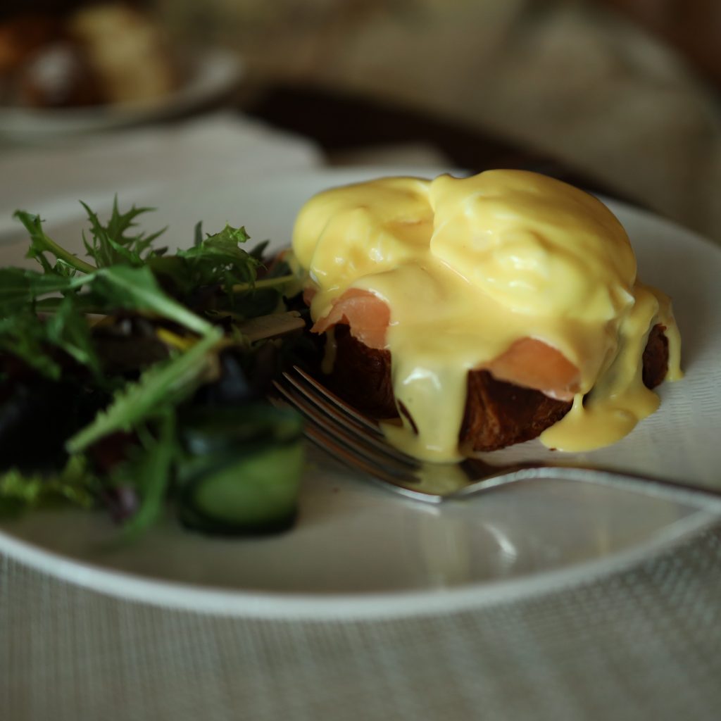 Cotton House Culinary Craft: A plate of Eggs Benedict, an exquisite dish with poached eggs, hollandaise sauce, and more.